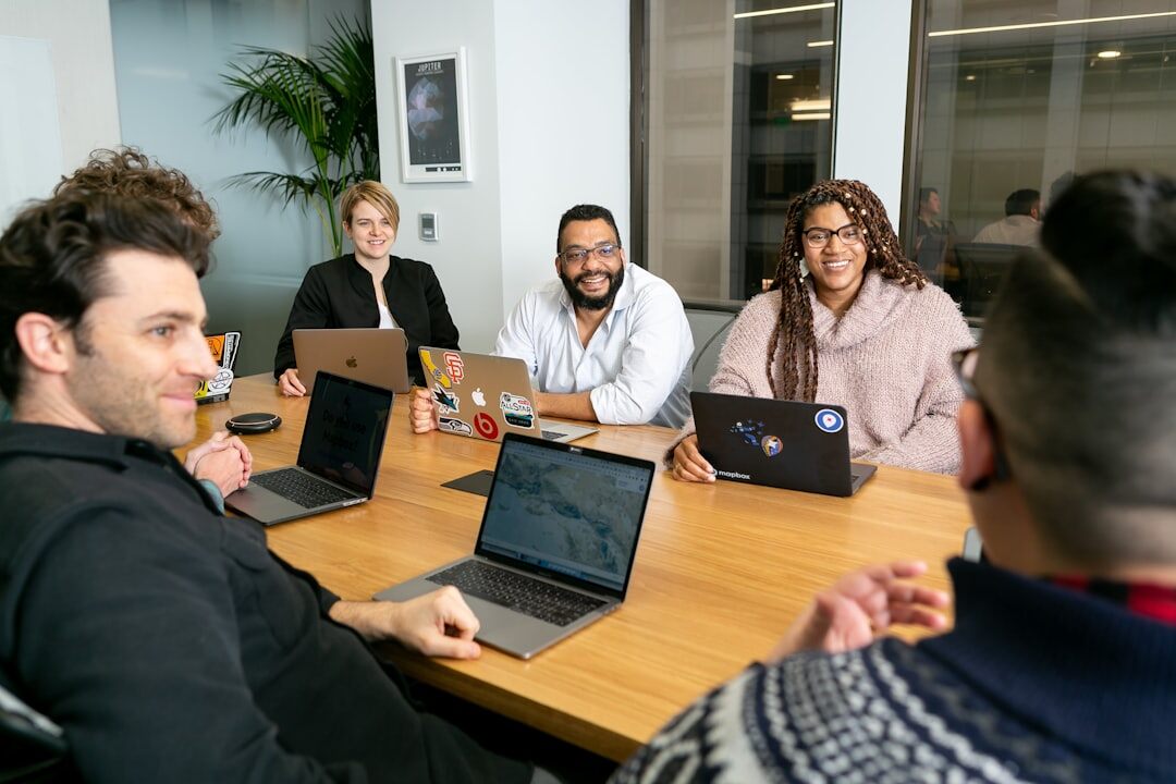 Diverse team of journalists working together in a modern newsroom