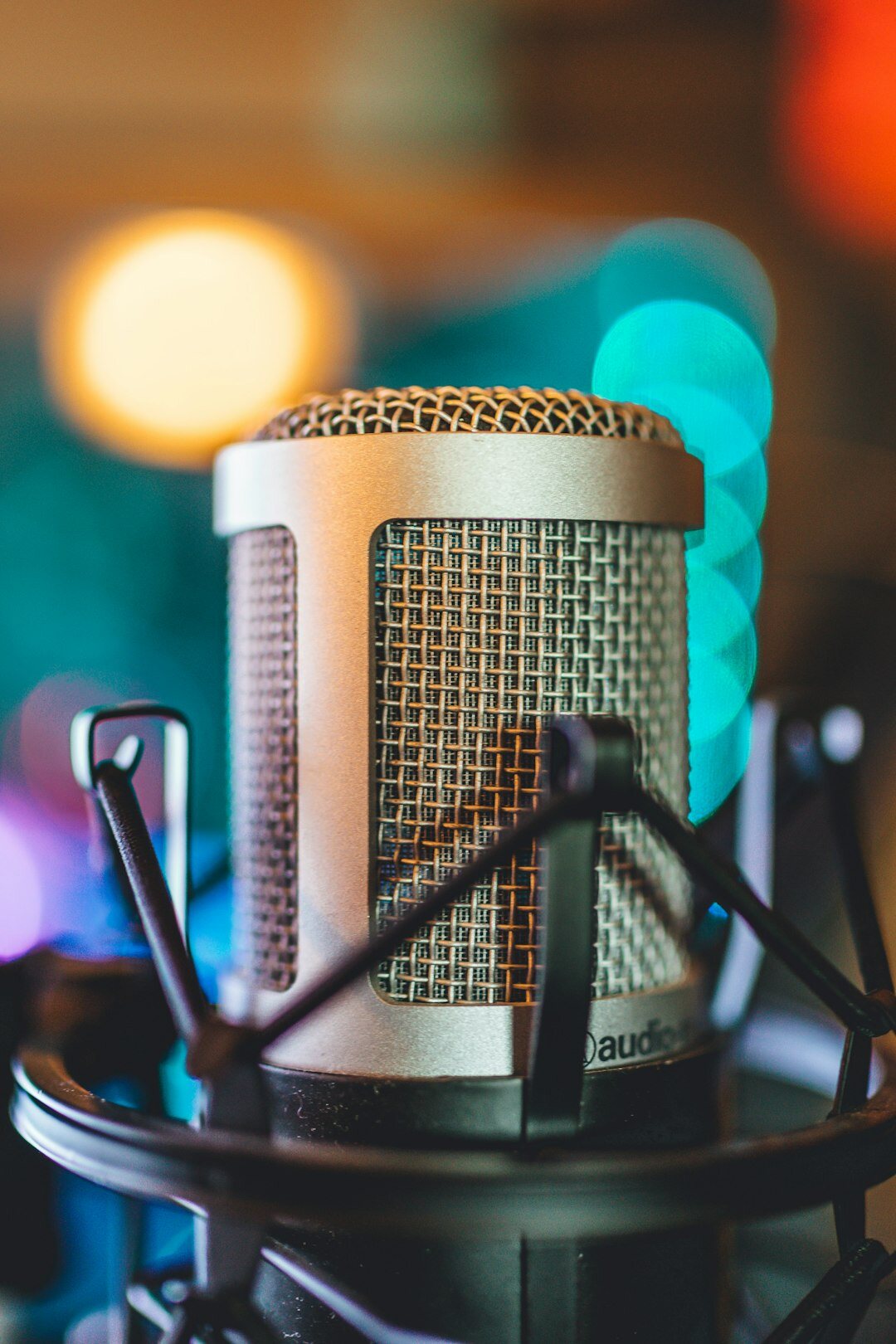 Close-up of a podcast host speaking into a professional microphone
