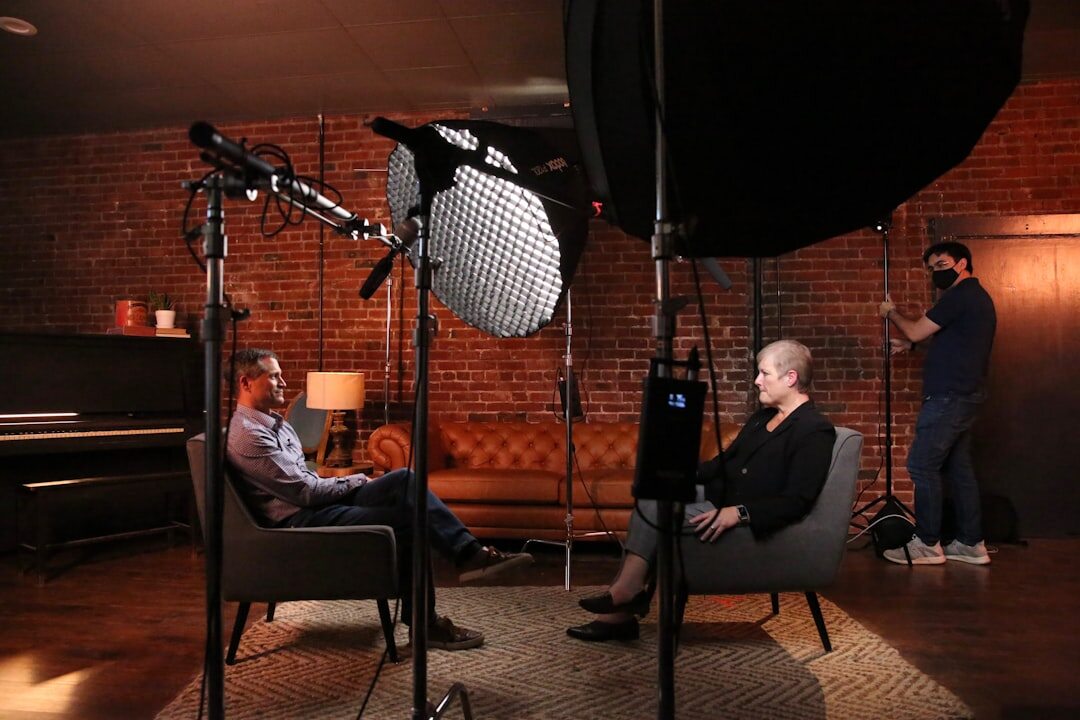 Television studio interview with host and guest seated under studio lights